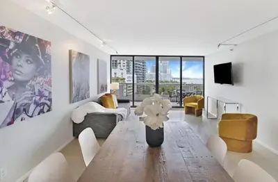 a living room with a vase of flowers on a table at Shore to Please! Park And Water Views! in Miami