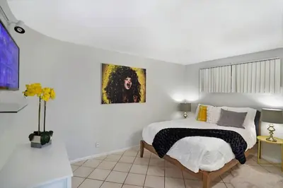 a bedroom with a bed and a painting on the wall at Shore to Please! Park And Water Views! in Miami
