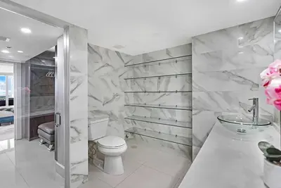 a bathroom with a toilet and a sink at The Marilyn! Renovated and Amazing Skyline Views! in Miami