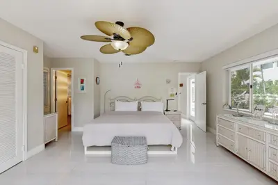 a bedroom with a bed and a ceiling fan at Sunny Oasis in Hollywood