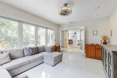 a living room with a couch and a large window at Sunny Oasis in Hollywood