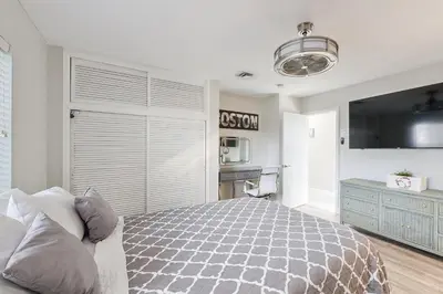 a bedroom with a large bed and a tv at Sunny Oasis in Hollywood