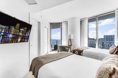 a hotel room with two beds and a flat screen tv at HydeHotel 2BED Lux Condo Ocean View Resort in Hollywood