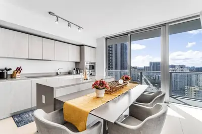 a kitchen with a table and chairs and a large window at HydeHotel 2BED Lux Condo Ocean View Resort in Hollywood
