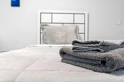 a pile of towels sitting on top of a bed at Trendy Family Home -Heated Pool in Hollywood