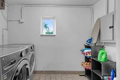 a washing machine in a laundry room with a window at Trendy Family Home -Heated Pool in Hollywood