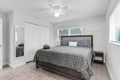 a bedroom with a bed and a ceiling fan at Trendy Family Home -Heated Pool in Hollywood