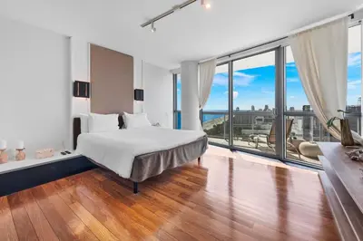 a bedroom with a bed and a large window at THE SETAI 5 STARS HOTEL-RESIDENCE MIAMI BEACH OCEANVIEW 2 Bedroom UNIQUE in Miami Beach