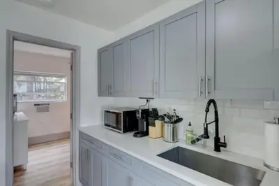 a white kitchen with a sink and a microwave at Bahama Mama Las Olas and Holiday Park w Hot Tub in Fort Lauderdale