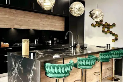 a kitchen with black cabinets and green bar stools at The Elements Home with 2 Pools in Fort Lauderdale