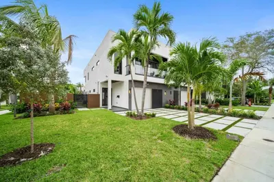 a house with palm trees in front of it at The Elements Home with 2 Pools in Fort Lauderdale