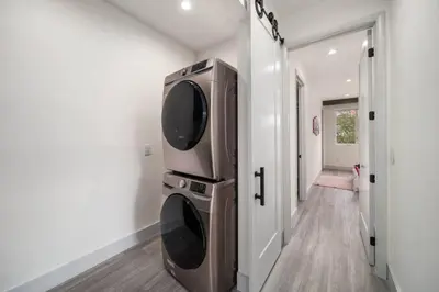 a large television in a room with a hallway at Luxury Home w 2 Pools near Beach in Fort Lauderdale