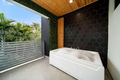 a bathroom with a white bath tub on a balcony at Luxury Home w 2 Pools near Beach in Fort Lauderdale