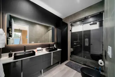 a bathroom with two sinks and a shower at Luxury Home w 2 Pools near Beach in Fort Lauderdale