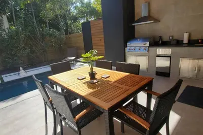 a wooden table and chairs in a kitchen at Luxury Home w 2 Pools near Beach in Fort Lauderdale