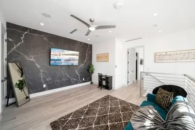 a living room with a couch and a wall at Luxury Home w 2 Pools near Beach in Fort Lauderdale