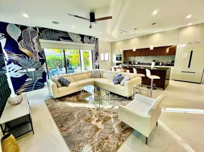 a living room with a couch and a table at The Botanicals Las Olas Near Beach in Fort Lauderdale