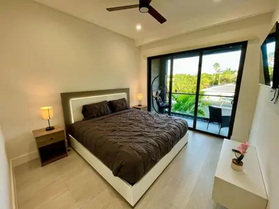 a bedroom with a bed and a large window at The Botanicals Las Olas Near Beach in Fort Lauderdale