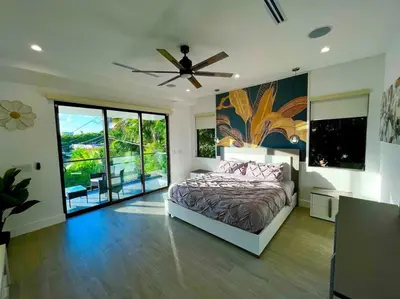 a bedroom with a bed and a ceiling fan at The Botanical Oasis Las Olas in Fort Lauderdale