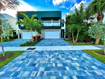 a villa with a driveway in front of a house at The Botanical Oasis Las Olas in Fort Lauderdale