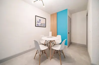 a dining room with a table and white chairs at Las Olas Newly Renovated Coastal 1BR Near Beach in Fort Lauderdale
