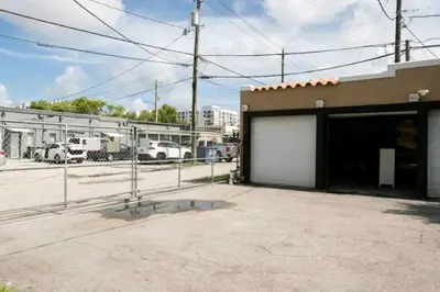 a parking lot of a building with a garage at Cozy Little Havana Apt Centrally located Hv2 in Miami