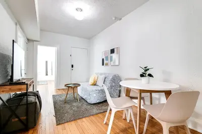 a white living room with a table and a chair at Cozy Little Havana Apt Centrally located Hv2 in Miami