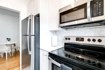 a kitchen with a stove and a microwave at Cozy Little Havana Apt Centrally located Hv2 in Miami