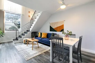 a living room with a blue couch and a table at Airport Loft 1b full kitchen Virg 10 in Miami