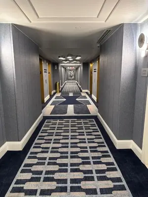 a hallway with a tile floor in a building at Fontainebleau Miami Beach,Tresor in Miami Beach