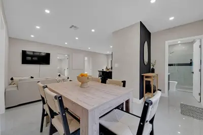 a dining room and living room with a table and chairs at Casa Copal: Relaxing Beach House in Hollywood
