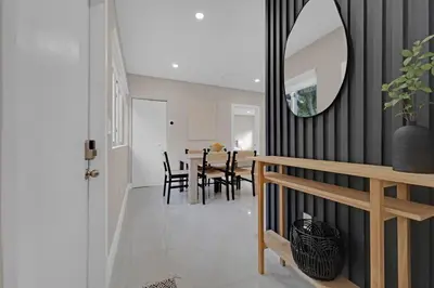 a dining room with a table and a mirror at Casa Copal: Relaxing Beach House in Hollywood
