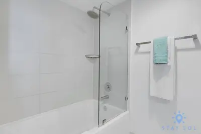 a shower with a glass door in a bathroom at Beachwalk Resort - Pool - Gym - Amazing view in Hallandale Beach