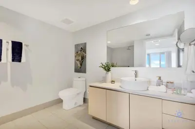 a white bathroom with a sink and a toilet at Amazing Pool - Apartment with Balcony and Gym in Hallandale Beach