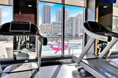 a gym with a view of a city at Infinite Views Amazing Pool Gym in Hallandale Beach