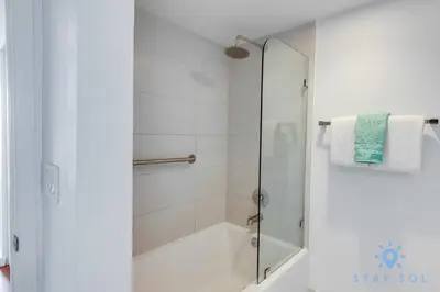a shower with a glass door in a bathroom at Infinite View Balcony - Amazing Pool - Gym in Hallandale Beach