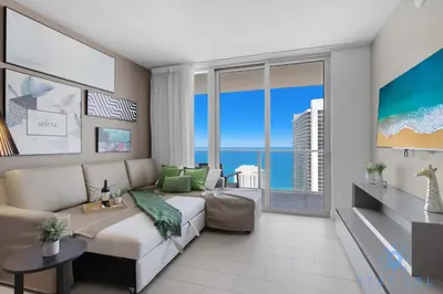a living room with a couch and a large window at Oceanfront Balcony Enjoy Endless Views Hot Tub in Hollywood