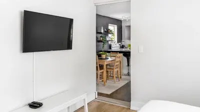 a living room with a flat screen tv on a wall at Brickell Pearl Cozy House Beach 10 min Location in Miami