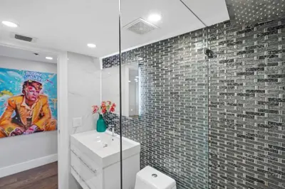 a bathroom with a sink and a painting on the wall at The Bond - OO7 Vibes and Penthouse Water Views! in Miami