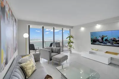 a living room with a couch and a table at Superstar! Penthouse with Water and Park Views! in Miami