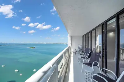 a balcony with chairs and a view of the ocean at Superstar! Penthouse with Water and Park Views! in Miami