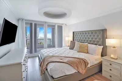 a bedroom with a large bed with a large window at Magic City! Water And Park Views! in Miami
