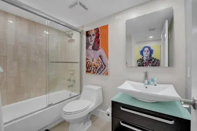 a bathroom with a toilet and a sink and a shower at Iconic! Miami Skyline & Water Views in Miami
