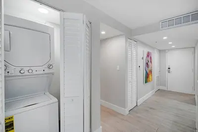 a kitchen with a stove and a white wall at Unforgettable! Water & Park Views, 4 Bedrooms! in Miami