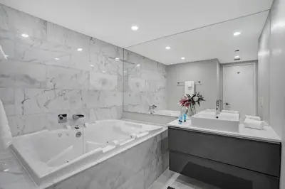 a bathroom with a large tub and a large mirror at Unforgettable! Water & Park Views, 4 Bedrooms! in Miami