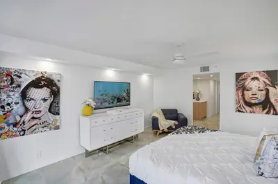 a bedroom with a bed and a tv on a wall at City of Dreams! Renovated With Water & Park Views in Miami