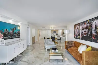 a living room with a couch and a table at City of Dreams! Renovated With Water & Park Views in Miami