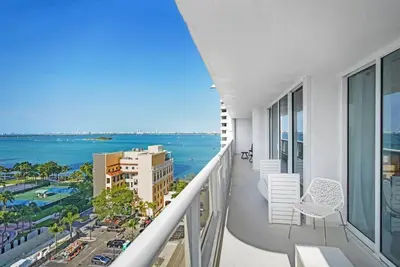 an apartment balcony with a view of the ocean at City of Dreams! Renovated With Water & Park Views in Miami