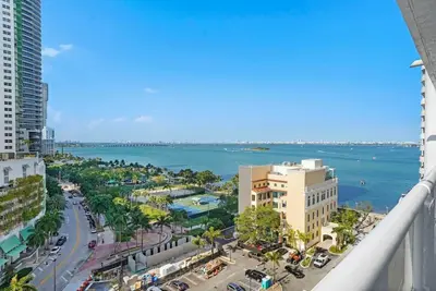 a view of a city with the ocean and buildings at City of Dreams! Renovated With Water & Park Views in Miami