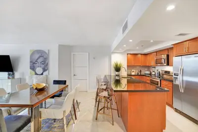 a kitchen with a dining table and a counter top at Some Like It Hot! Miami Skyline & Water Views 4BR in Miami